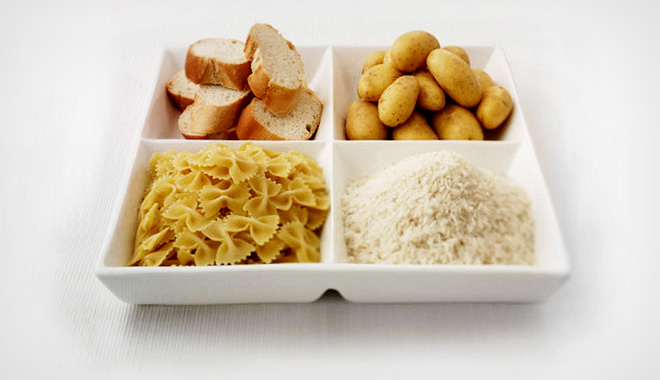 Close up of sectioned plate with bread, potatoes, rice and pasta